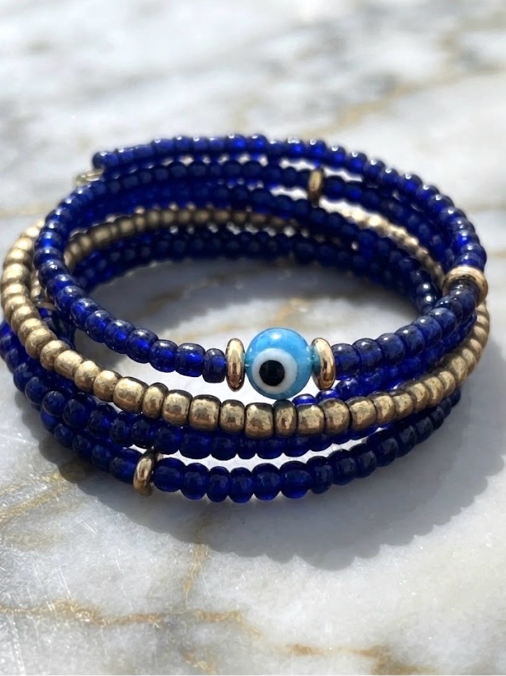 Artisan Blue Glass Beaded Coil Bracelet with Gold Accents and Evil Eye